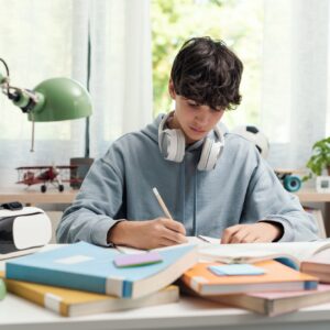 Teenager studying at home alone